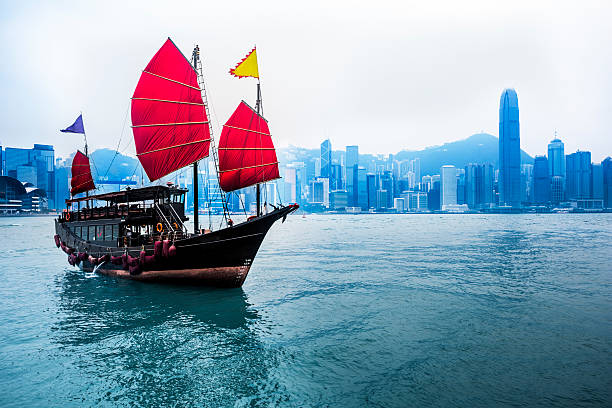 Junkboat  of hong kong Traditional Chinese Junkboat sailing across Victoria Harbour at day,  Hong Kong the bank of china tower stock pictures, royalty-free photos & images