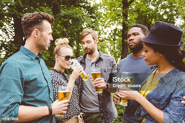 Multi Ethinc Friends Drinking With Beer Outdoors Stock Photo - Download Image Now - 2015, Adult, African Ethnicity