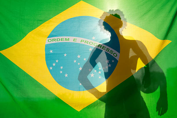 istock Man Holding Football Shadow Brazil Flag 491872807