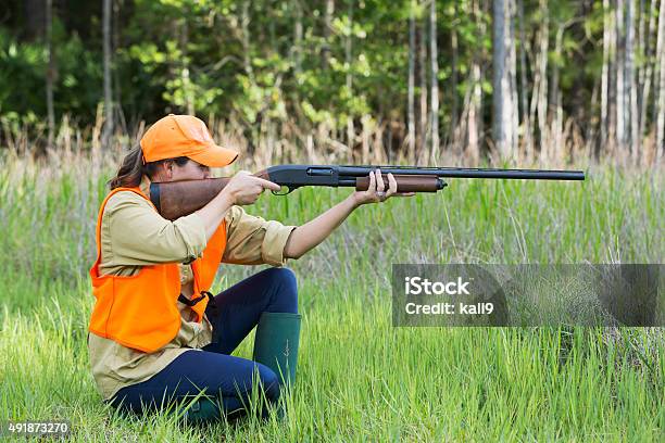Female Hunter With Shotgun Kneeling In Tall Grass Stock Photo - Download Image Now - Hunting - Sport, Hunter, Women