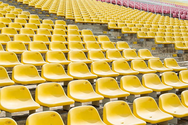 istock Field of empty yellow plastic stadium seats. 491873347
