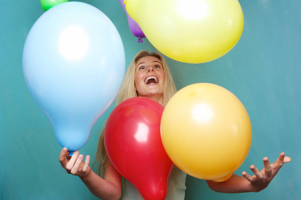 istock Blond woman playing with balloons 491873845