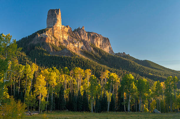 Warm Glow on Chimney Rock near Owl Creek Pass Autumn sunset on iconic Chimney Rock. Located in Uncompahgre National Forest and accessed via Owl Creek Pass. Chimney Rock is near the town of Ridgway, Colorado. ridgway stock pictures, royalty-free photos & images