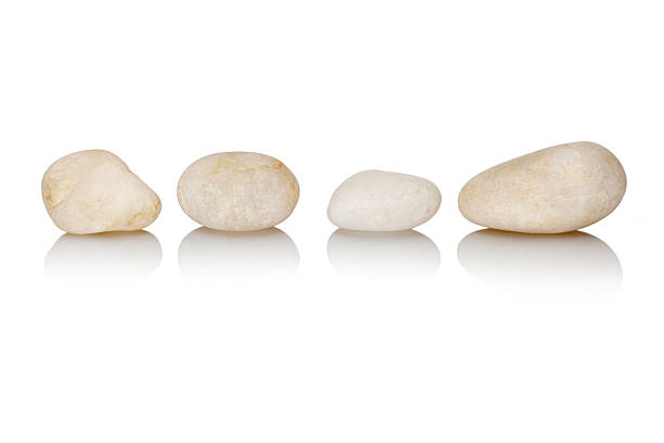 four  white spa stones isolated stock photo