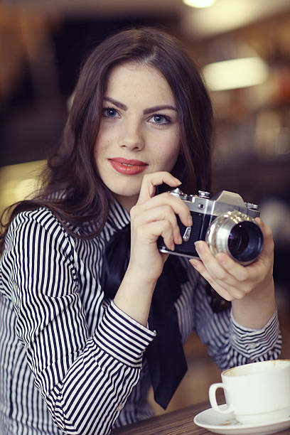 istock young girl with a vintage camera 491888446