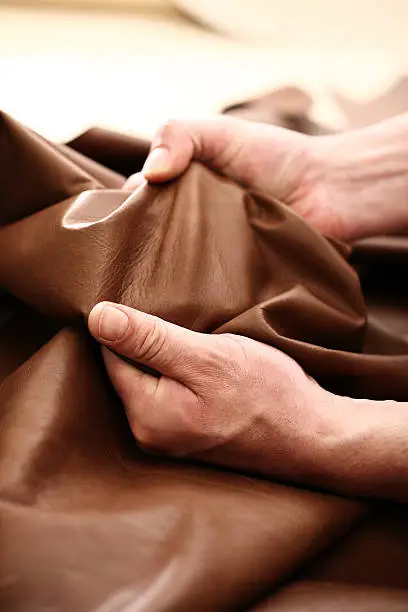 Hands tailor to check the quality of the material 