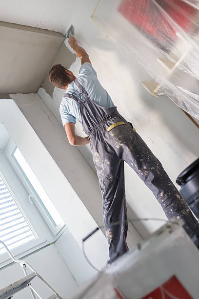 istock Plasterer renovating indoor walls and ceilings. 491889890