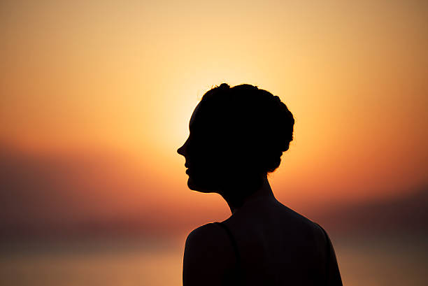 istock Woman in silhouette during sunset 491890413