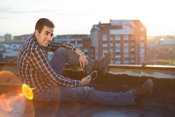 istock Young man enjoying music on smartphone 491890839