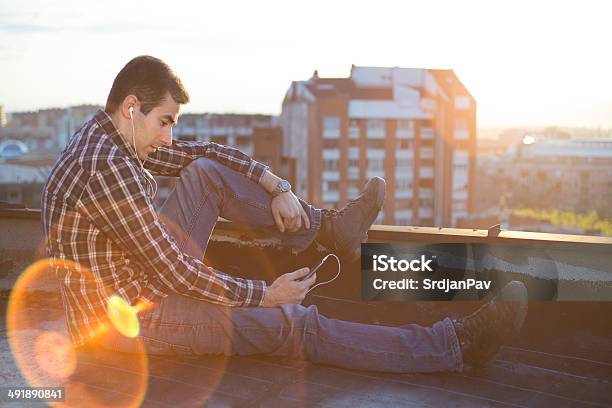 Young Man Listen Music In Sunset Stock Photo - Download Image Now - Adult, Adults Only, Attitude