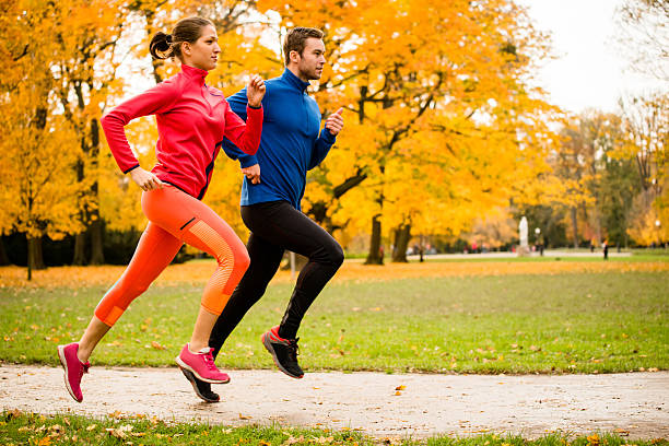 Couple jogging in autumn nature stock photo