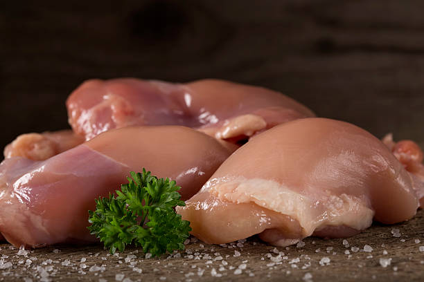 Raw boneless chicken thighs stock photo