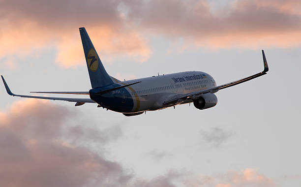 Ukraine International Airlines Boeing 737-800 aircraft in the sunset rays stock photo