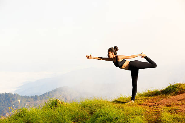 istock Young woman exercises yoga 491892079