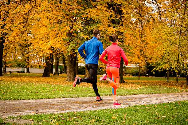 istock Couple jogging in autumn nature 491892994