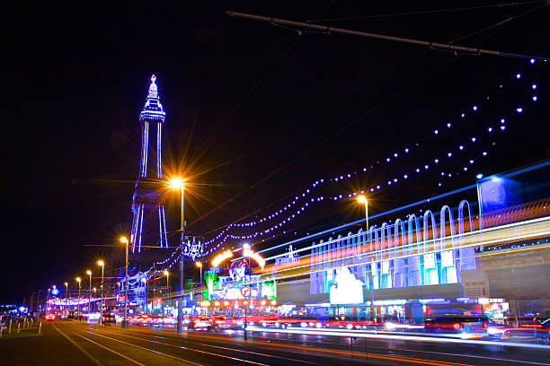 Blackpool Tower and The Golden Mile Illuminations at night The Famous Blackpool Tower and lights along the stretch of promenade known as the Golden Mile in Blackpool, Lancashire at night, photographed on a long exposure with light streaks during the yearly 'illuminations' spectacle. lancashire photos stock pictures, royalty-free photos & images