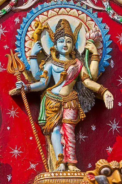 Shri Ardhanarishwara (literally Half-Woman God), traditional image of Parvati and Shiva in one body. Image on the wall of ancient Kali temple in Puri, Orissa