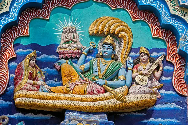 Image of Vishnu Padmanabha on the snake Shesha with Lakshmi, Saraswati and Brahma on the temple wall in Puri