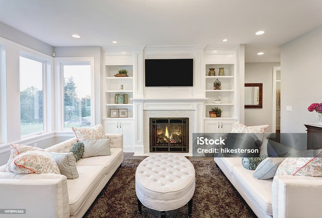 Living Room in Luxury Home furnished living room in newly constructed home Fireplace Stock Photo