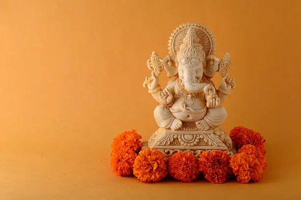 Photo of Hindu God Ganesha. Ganesha Idol on Yellow Background.