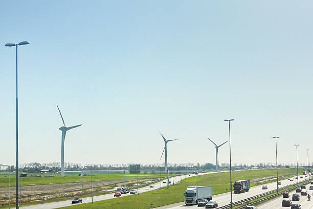 istock Wind generator turbine in a street highway background 491905812