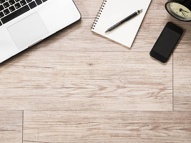 istock Laptop computer, notebook , smartphone and alarm clock on wooden desk 491908814