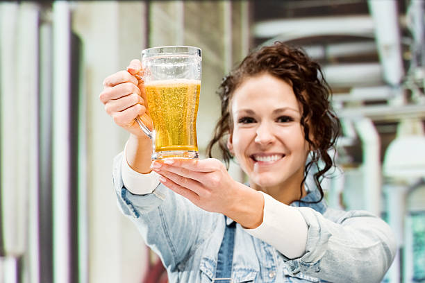 istock Cheerful female brewmaster holding glass 491909192