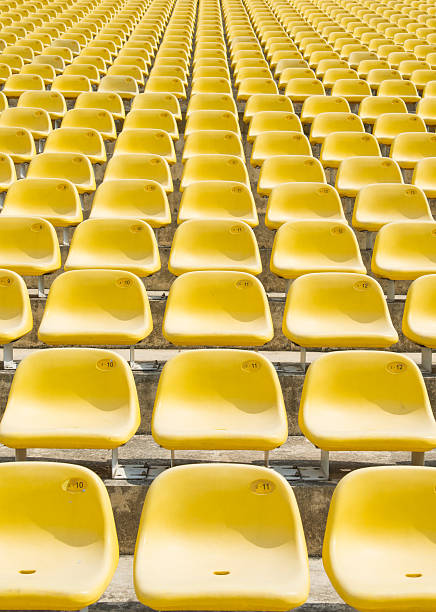 istock Field of empty yellow plastic stadium seats. 491910109