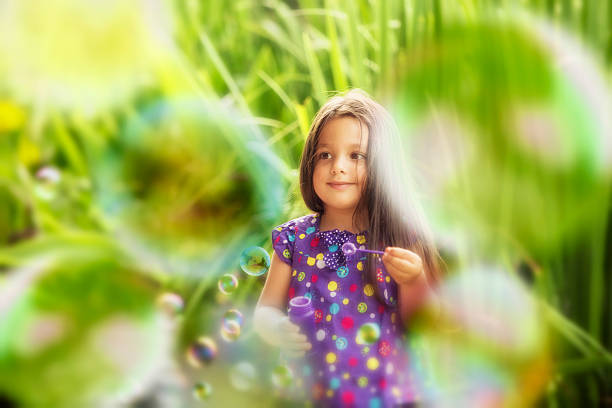 Cute Little Girl Blowing Bubbles