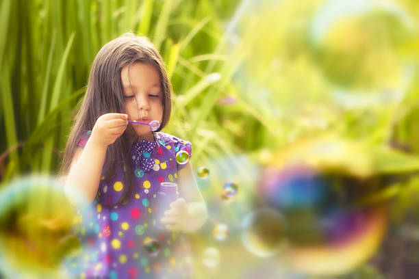 istock Cute Little Girl Blowing Bubbles 491910615