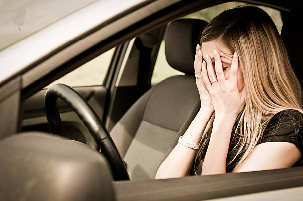 In troubles - unhappy woman in car stock photo