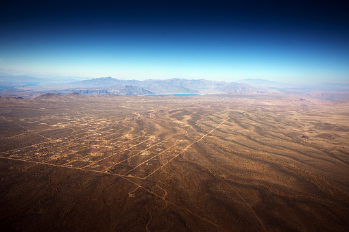 The reservation is south of the Grand Canyon and this shot is from a helicopter looking towards Lake Mead. The settlement in the foreground is Meadview.