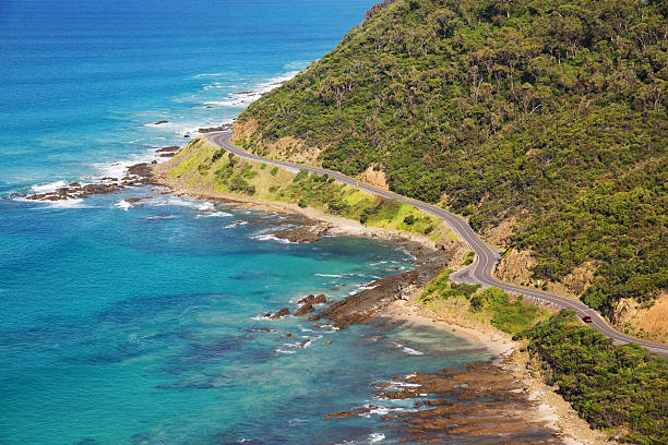 Great Ocean Road A winding section of the Great Ocean Road in Victoria, just part the town of Lorne. The scenic road winds down the coast of Victoria and is popular with tourists. great ocean road photos stock pictures, royalty-free photos & images