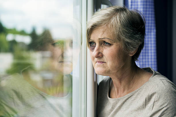 Domestic violence Scared woman is looking through the window. Having bruise on her face black eyes stock pictures, royalty-free photos & images