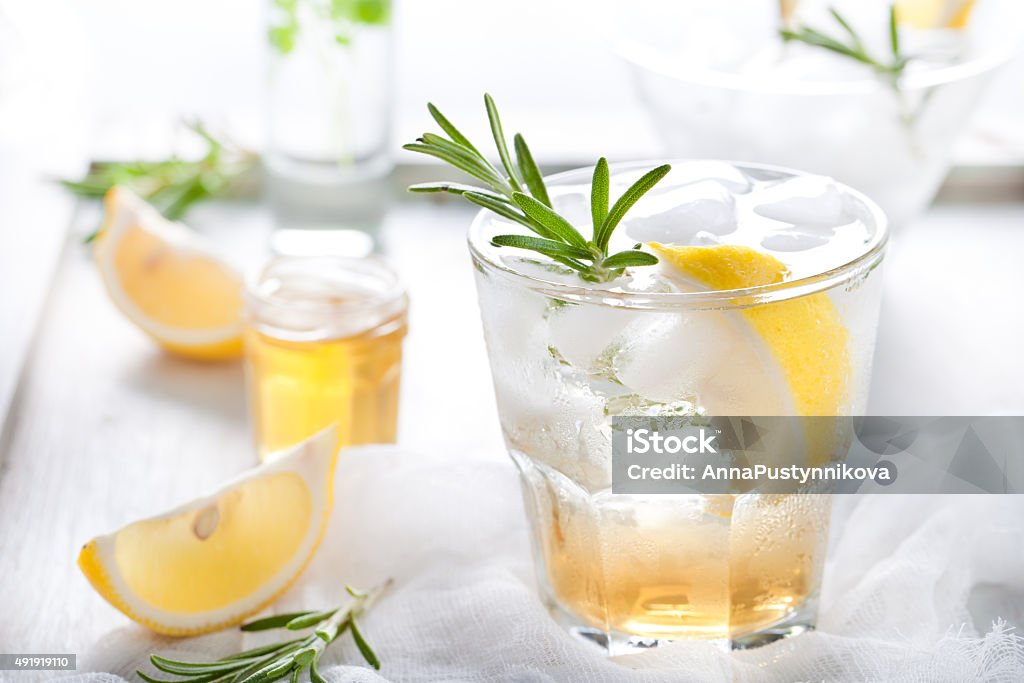 Gin,lemon, rosemary fizz, cocktail Gin,lemon, rosemary fizz, cocktail with honey and fresh herbs Ginger - Spice Stock Photo