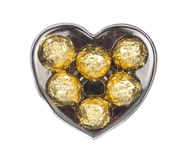 istock Gold chocolate in heart shape box isolated on white 491924914