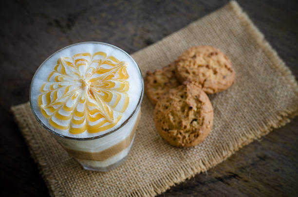 hot latte art coffee and cookie