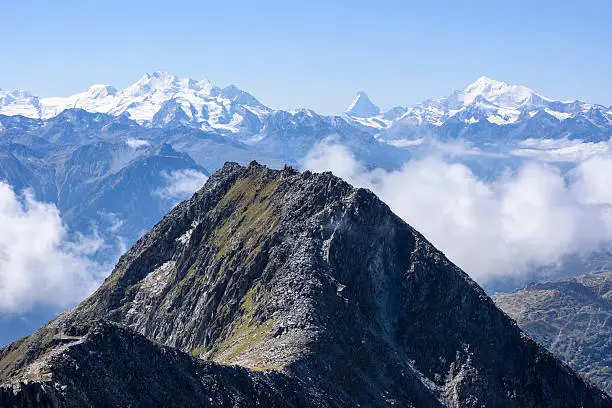 The mountain Bettmerhorn (2872 m) in the foreground and in the background the mountains Matterhorn (middle, 4478 m), Weisshorn (right, 4505 m), the Mischabel group (left, the highest peak of the group is the Dom, 4545 m), taken from the Eggishorn (2.926  m), Switzerland, European Alps.