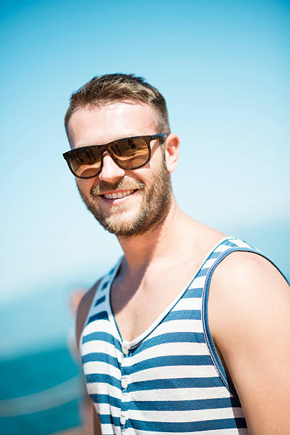 istock Handsome and Smiling Young Man with Sunglasses on Beach 491936288