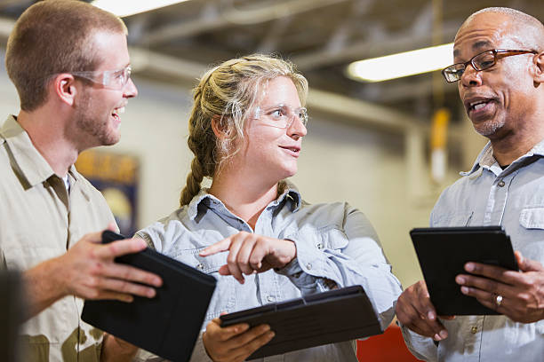 istock Team of repairmen talking and holding digital tablets 491937108