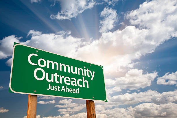 istock Community Outreach Green Road Sign Over Clouds 491938050