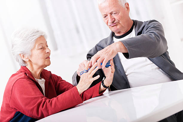 istock Senior couple playing cats cradle 491939135