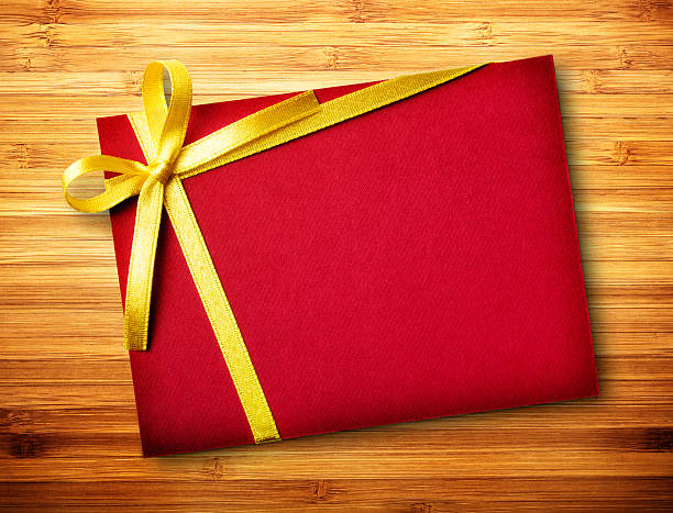 istock Red card with gold bow on wood 491940041