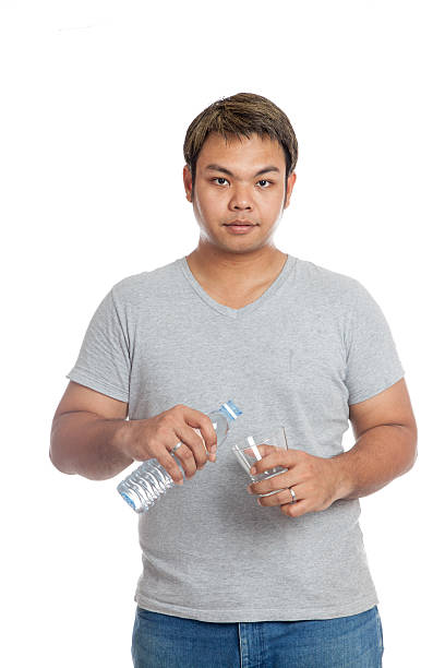 istock Asian strong man pour water into a glass 491941011
