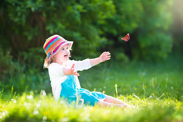 istock Cute toddler girl playing with butterfly 491942773