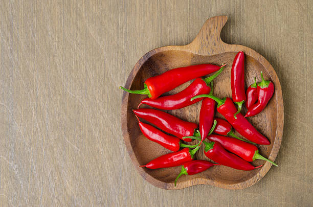 istock wooden bowl with red chili peppers (and space for text) 491943389