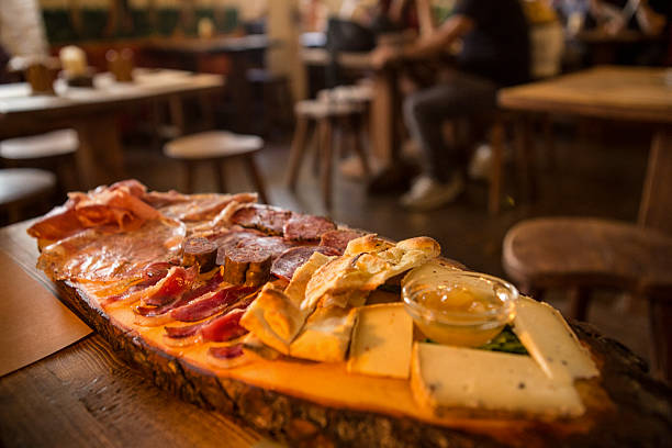 Platter of cold cuts and cheeses Platter of cold cuts and cheeses, Splendito platter of Italian cold cuts and cheeses, Ascoli Piceno, in the Marche region, Italy. marche italy stock pictures, royalty-free photos & images