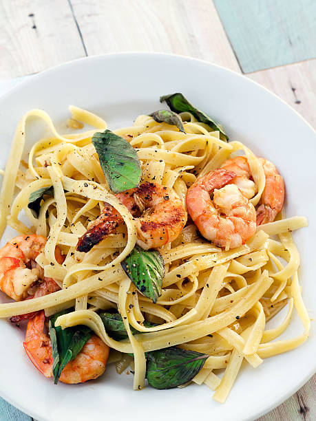 istock Fettuccini with shrimps and basil leaves 491950440