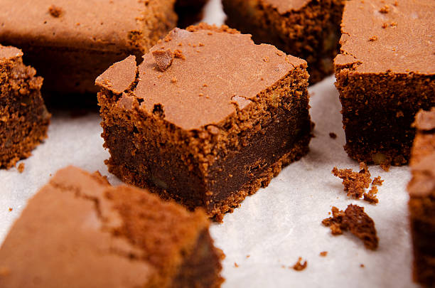 istock chocolate brownie diced  baking paper on a wooden table 491951064