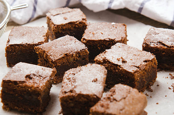 istock chocolate brownie diced baking paper on wooden table with a 491951080